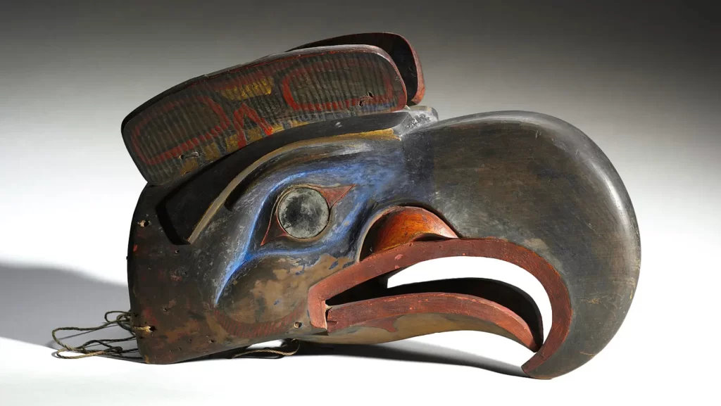 Kwakwaka’wakw transformation mask depicting a bird, featuring intricate carvings and vibrant colors, embodying traditional Indigenous design and symbolism from the Pacific Northwest